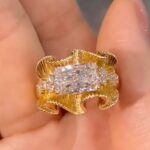 sculptural gold silk ribbon ring with east west diamond