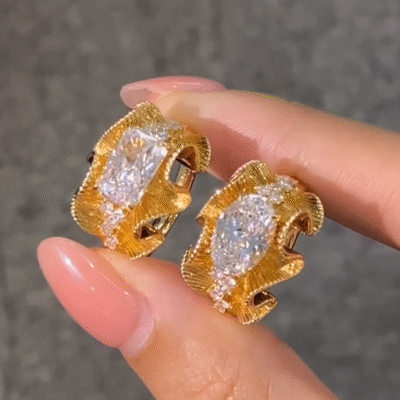 sculptural gold silk ribbon ring with east west diamond