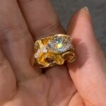 sculptural gold silk ribbon ring with east west diamond