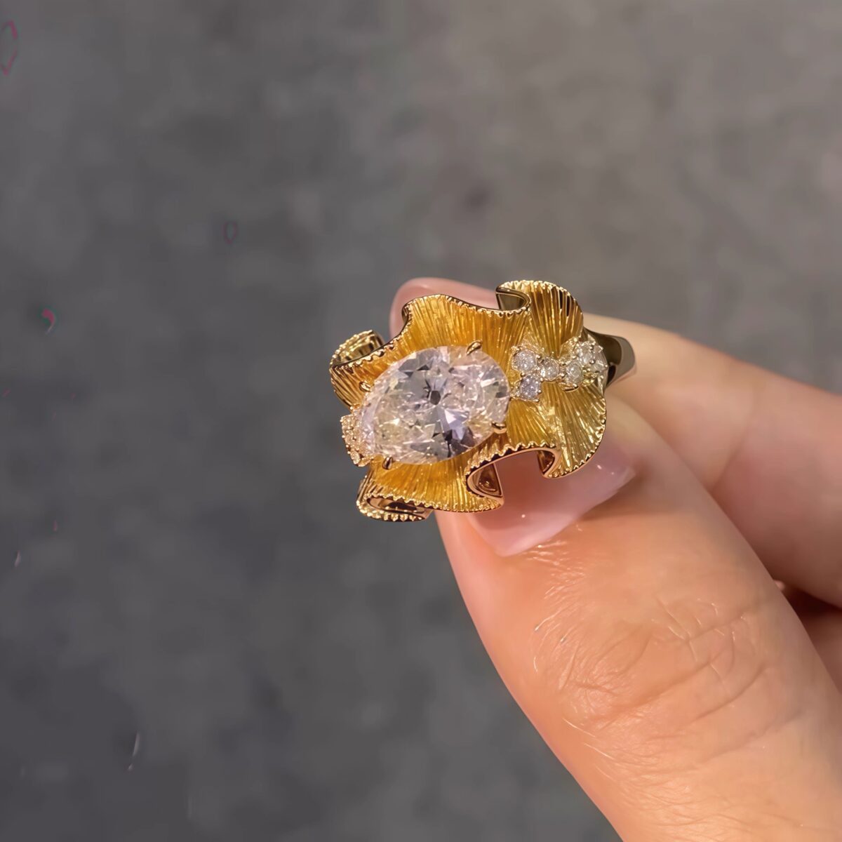 sculptural gold silk ribbon ring with east west diamond