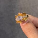 sculptural gold silk ribbon ring with east west diamond