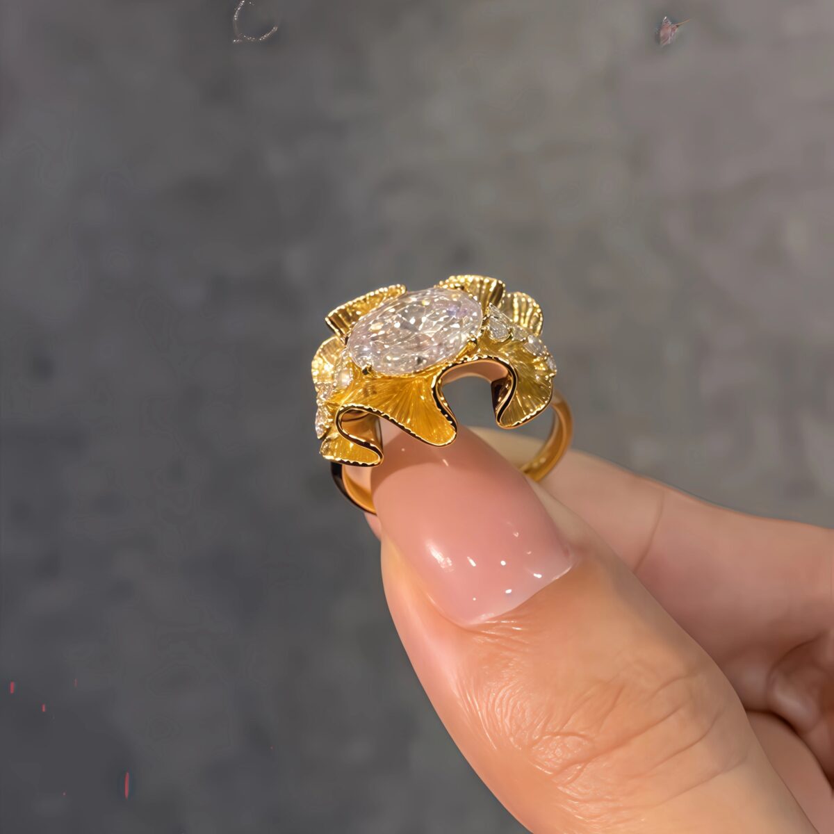 sculptural gold silk ribbon ring with east west diamond