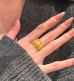 sculptural gold silk ribbon ring with east west diamond