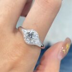 three stone lab diamond ring – round center with marquise side stones and pavé halo